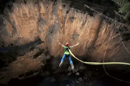 man bungee jumping in the mountain nature and adrenaline